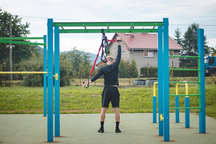 athlete-stretches-strengthens-his-arms-shoulders-pectoral-muscles-with-trx-fitness-straps_1048944-2273855