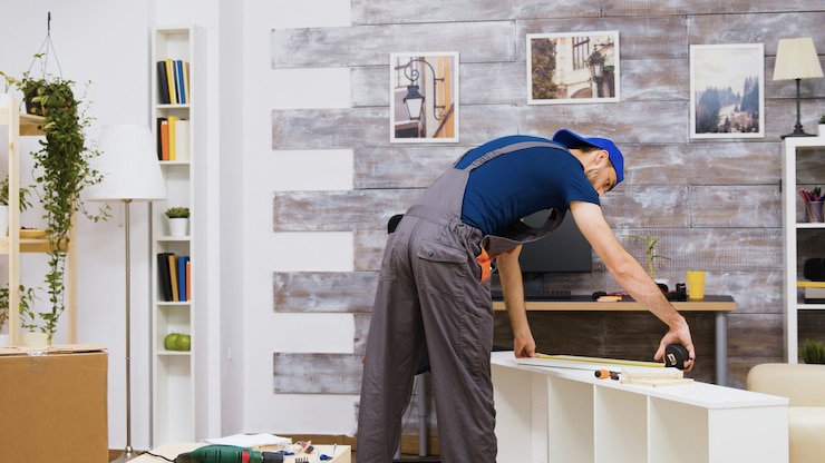 furniture-assembly-worker-standing-reading-instruction-using-tape-measure-worker-tools_482257-24849